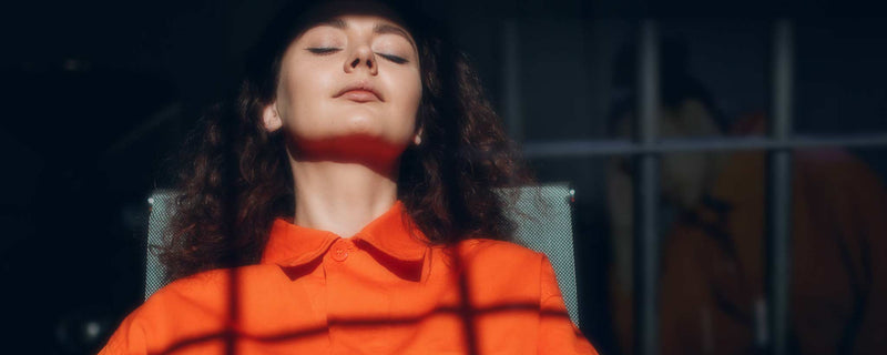 Female with orange prison jumpsuit