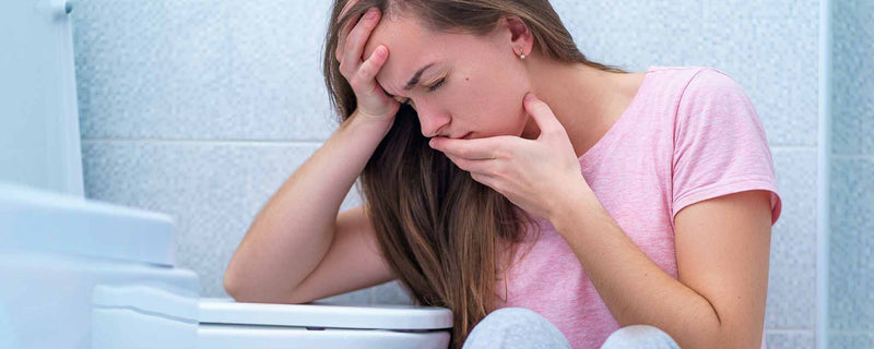 Female puking in toilet