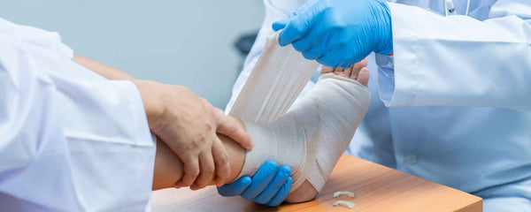 Doctor wrapping foot injury