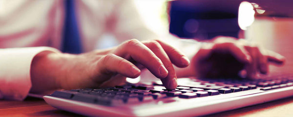 Male hands typing on keyboard