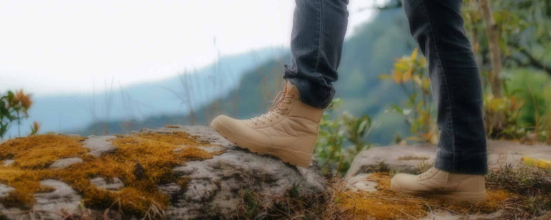 Male boots on mountain cliff