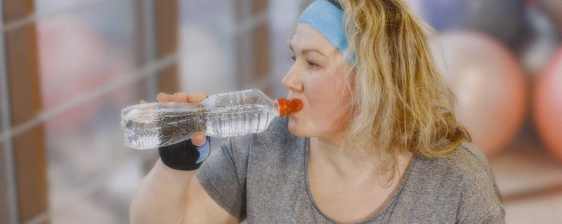 Plus-size female drinking water