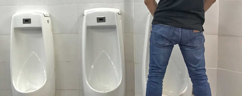 Man using urinal