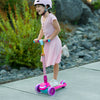 young girl riding pink princess kick scooter