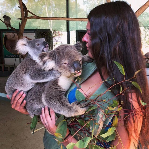 Tess, OllyDog Team Member holding two koala bears.