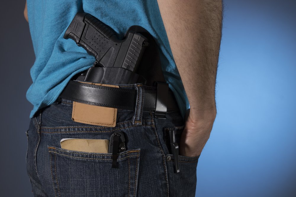 Closeup of a gun tucked into pants