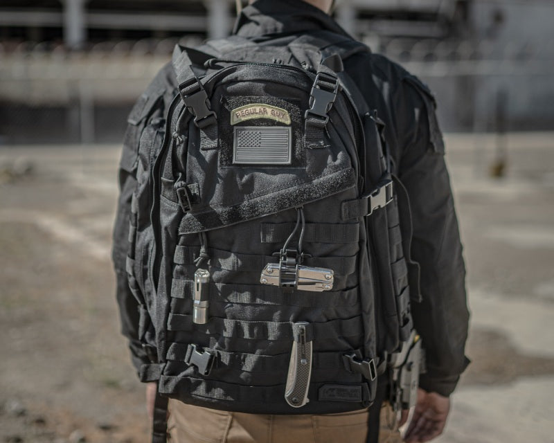 man wearing backpack with MOLLE