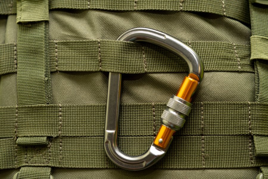 Close up of MOLLE panel on tactical luggage with a carabiner