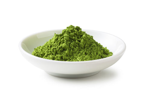 A white bowl full of culinary grade matcha tea powder.