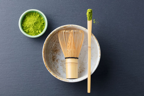 Tools such as brush and bowl used for matcha preparation.