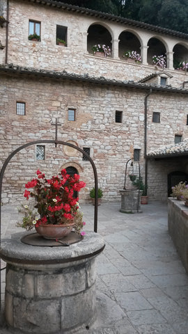 The small courtyard and well before entering the 'Sanctuario' at the hermitage near Assisi Italy