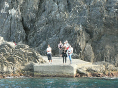 Passengers wait on the 'jetty' for the ferry at Vernazza