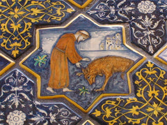 Francis and the Gubbio wolf on a ceramic tile in Deruta