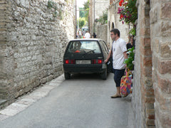 Watch out for cars when walking through Italian towns