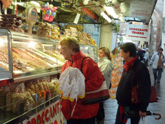 Marg & Win check out a nut stall at Assisi St Francis market