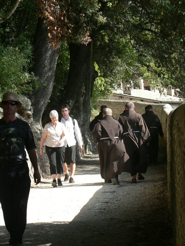 Friars hurry along the path to the hermitage near Assisi