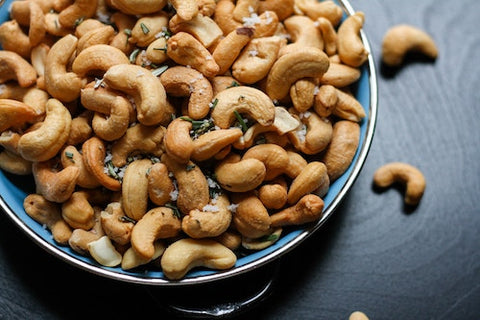 Assorted cashews in a blue bowl
