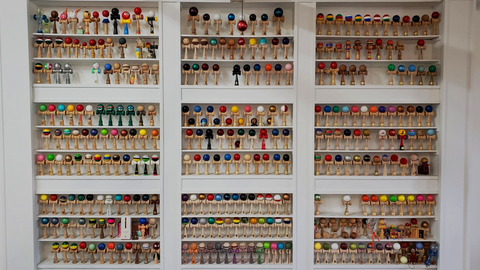 rows of colorful kendamas on a wall