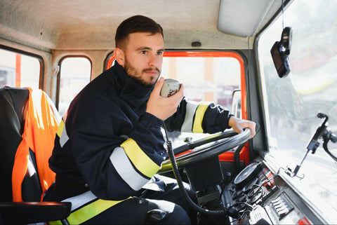 firefighter using an emergency radio in a fire truck