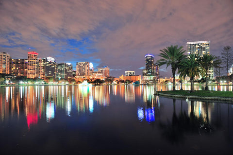 Orlando city lights reflecting over body of water 