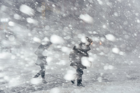 Two people walking during a blizzard