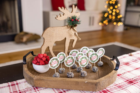 Raspberry Dark Choc Frooze Balls on a charcuterie board with reindeer decor