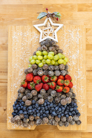 Frooze Balls and other fruits on a charcuterie board to make the shape of a Christmas Tree