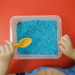 July 4 sensory bin with blue rice