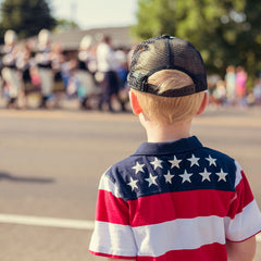 Child attending a 4th of July parade to participate