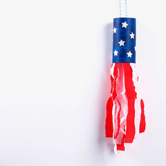 A blue wind ornament with red and white streamers as a 4th of July activity