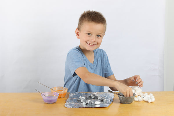 Kid plays with a Halloween sensory box