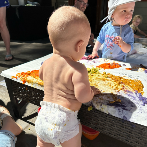 Infant plays with Thanksgiving food activity.