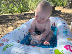 Messy Play Baby in bath tub on road trip.