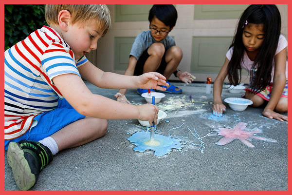 3 Kids doing a fizzing chalk 4th of July activity