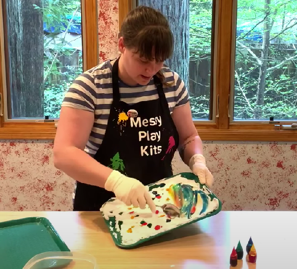 Robin smears and mixes colored shaving cream for marbling easter eggs