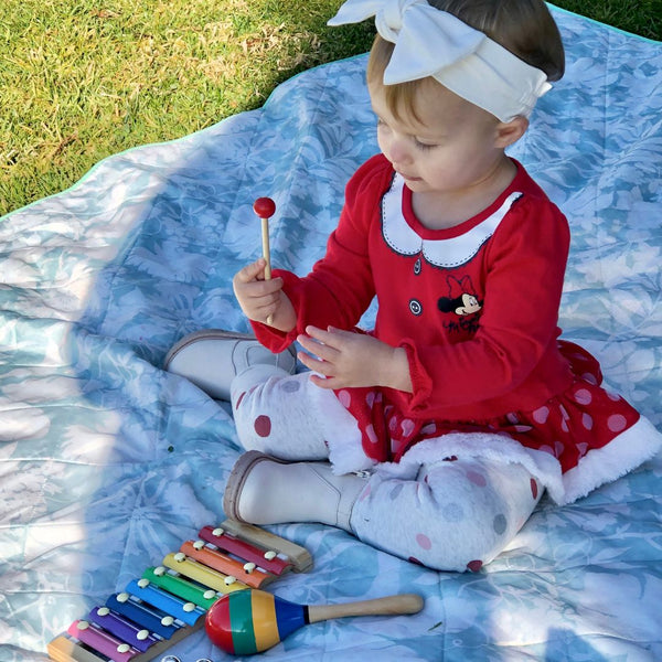 A girl plays an instrument.