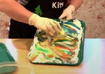 Rolling an egg in shaving cream colored with food coloring