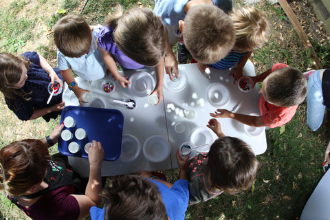 Children prepare for slime sensory play.