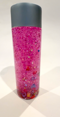 Valentine's Day sensory bottle with pink glitter and hearts.