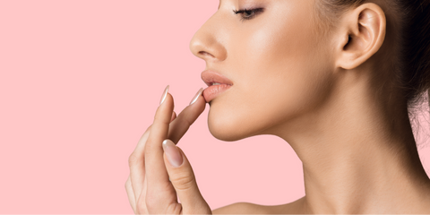 Girl Touching Her Lips Pink Background