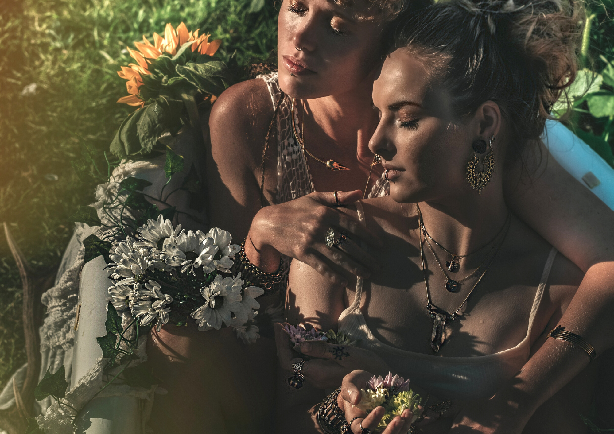 two women in outdoor boho bath with beautiful jewellery, silver rings, bird skull necklace, quartz crystal jewellery, forage design