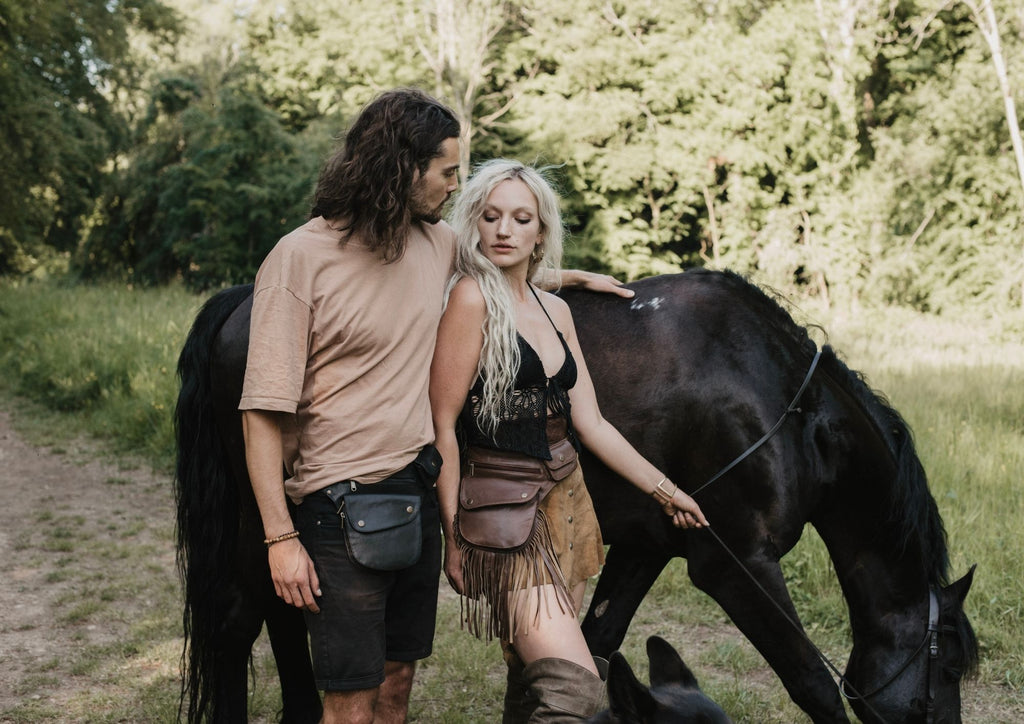 In the world of horse riding, a woman confidently navigates the terrain with her trusted steed and faithful companion. Her leather belt bag serves as a stylish and functional accessory, keeping her riding essentials secure and easily accessible, elevating her equestrian experience. (Keywords: horse riding, terrain, trusted steed, faithful companion, leather belt bag, riding essentials)