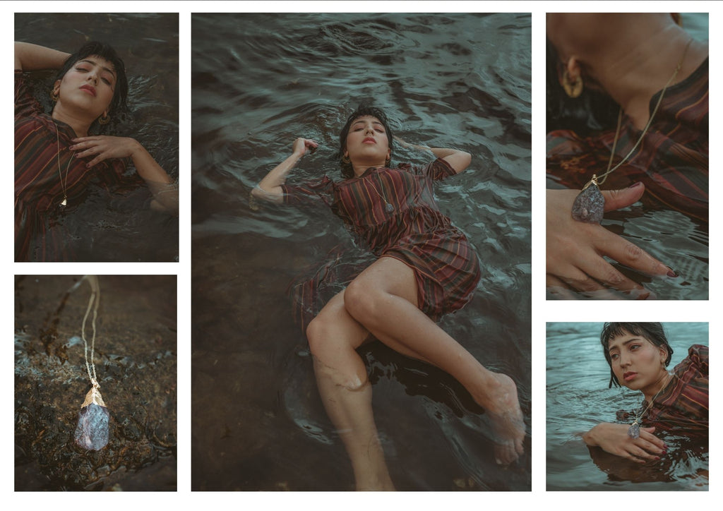 mari schaeper floating in the water with raw labradorite crystal necklace and boho style jewellery and hippie clothing