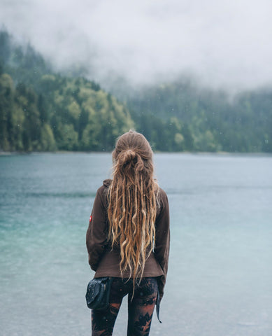 Jamylein wearing a Forage pocket belt looking over a beautiful lake and misty mountains |   international women’s day, happy international women’s day, mother nature