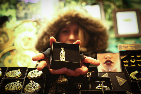 Person holding out gift box with ethical jewellery. Forage donate to charity with every purchase of fair trade clothing and  sustainable fashion 