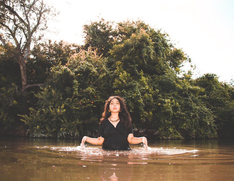 Marifer Scheper standing in a river, fully clothed, wearing Bohemian jewellery from Forage Design | mother earth, mother earth goddess, how to take care of mother earth, how to give back to mother earth