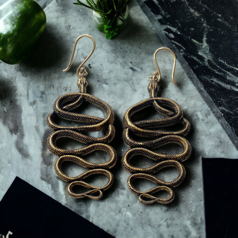 Entining snake earrings | Serpent mystique in paganism, Serpent as a symbol of wisdom, Snake symbolism in ancient cultures, Serpent-themed accessories in witchcraft, The allure of serpent motifs, Serpent symbolism in contemporary style, Serpent-themed jewelry collection