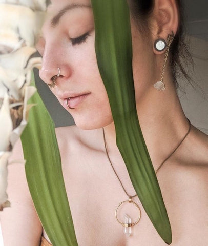 A woman, eyes closed surrounded by beautiful plants and wearing crystal jewellery | silver jewellery, mother earth, powerful women, gemstone jewellery, gifts from independent businesses
