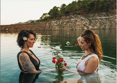 Zaphire Phoenix & Lux Lucis wearing Forage Jewellery standing fully vlothed in a lake holding flowers | silver jewellery, mother earth, powerful women, gemstone jewellery, gifts from independent businesses