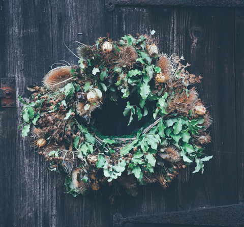 evergreen yule wreath, rustic Christmas decoration on a wooden door 